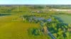 An aerial view of green space in Cudahy, Wisconsin, with green fields, trees and wind turbines.