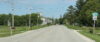 A rural road with no sidewalks cuts through the center of Maplewood, Wisconsin.