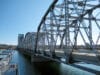 A closeup image of the Sturgeon Bay Bridge in Sturgeon Bay, Wisconsin, spans across open water. The bridge is characterized by it's lattice work of steel struts.