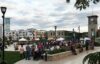 People gathered around on a cool day in downtown Oak Creek, Wisconsin.
