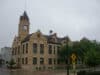 A building with a clock tower in downtown Oconomowoc, Wisconsin.