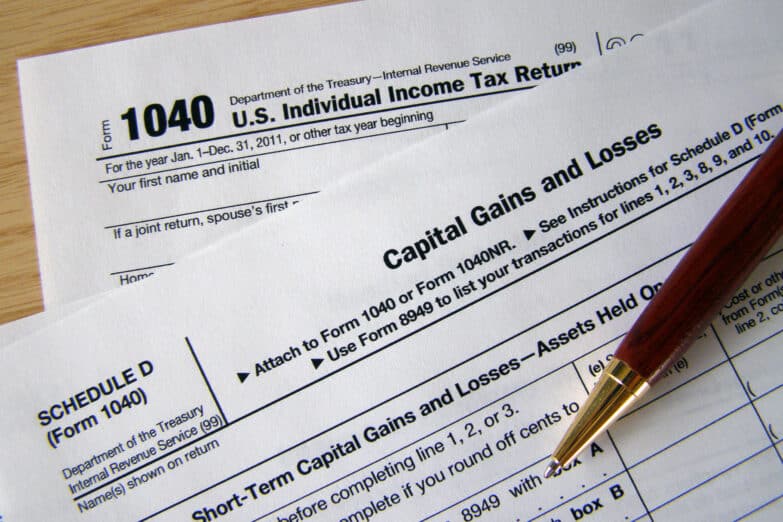 A close-up photo of the top of a 1040 tax return with a pen on the document.