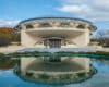 The famous Annunciation Greek Orthodox church, along with its reflection in a pond in front of the church, is a famous structure in Wauwatosa, Wisconsin. The church has a circular, slightly domed roof.